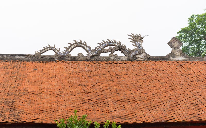 Common stone dragon on top of temple roof in Vietnam royalty free stock photo Common stone dragon on top of temple roof in Vietnam royalty free stock photo