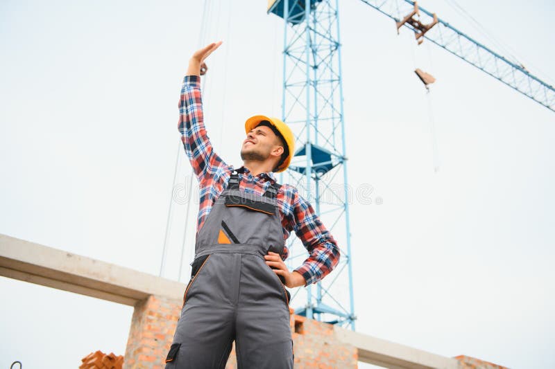 Communicating with Crane Guy. Construction Worker in Uniform and Safety
