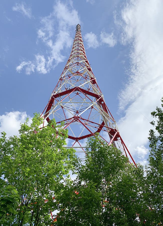 Communication Radio Tower among the Trees Against the Blue Sky Stock Image - Image tall, transmission: 221261193