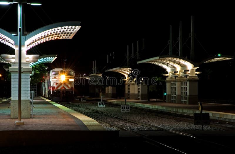 Open air commuter train station at night. Night train stock images, royalty-free photos and pictures