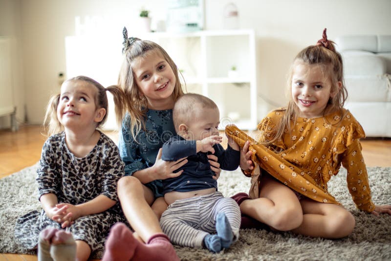 As elderly sisters, we take care of them as small ones. Group of children at home. As elderly sisters, we take care of them as small ones. Group of children at home