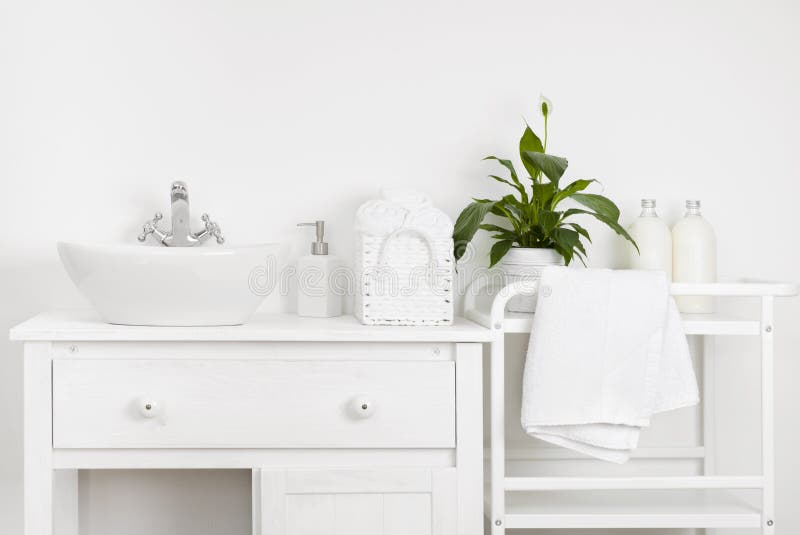 Compact bathroom interior with white vintage furniture, shelf, towels and sink royalty free stock photo Compact bathroom interior with white vintage furniture, shelf, towels and sink royalty free stock photo