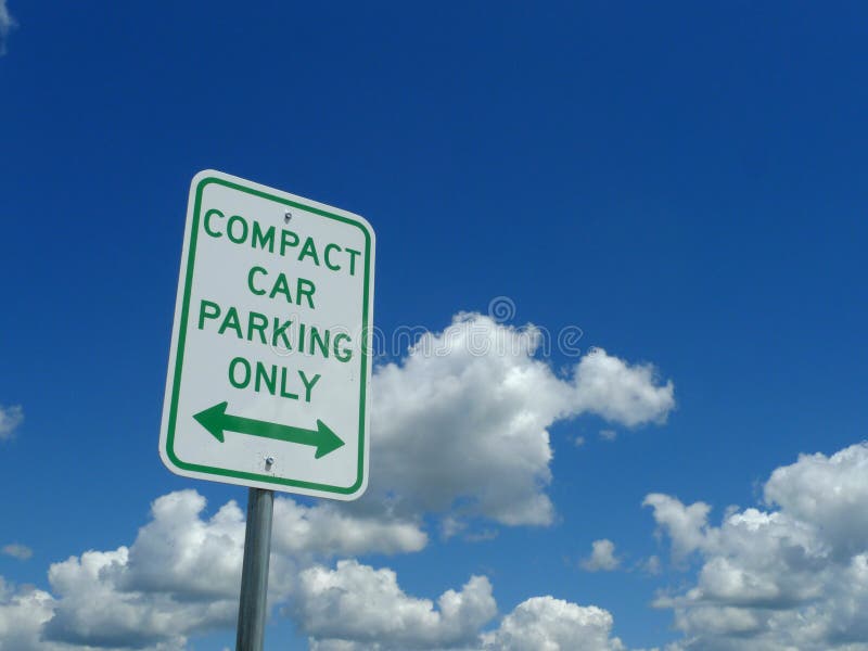 Compact Car Parking Only Sign with blue sky and clouds