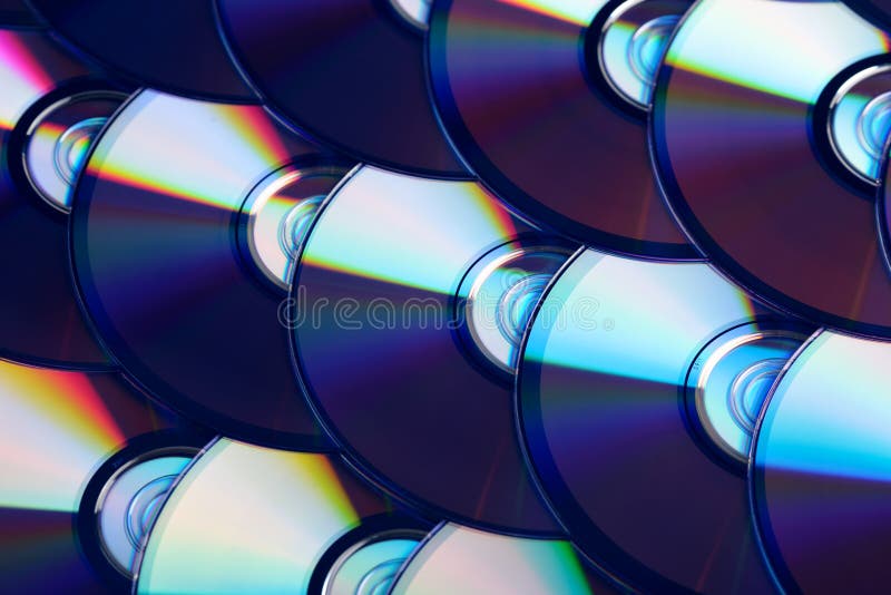 Compact discs background. Several cd dvd blu-ray discs. Optical recordable or rewritable digital data storage.