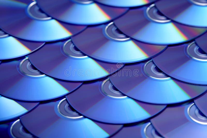 Compact discs background. Several cd dvd blu-ray discs. Optical recordable or rewritable digital data storage. royalty free stock photo