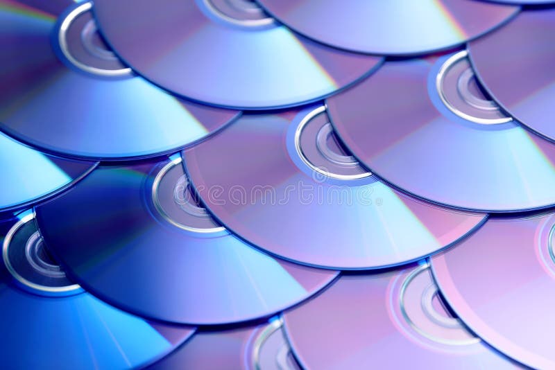 Compact discs background. Several cd dvd blu-ray discs. Optical recordable or rewritable digital data storage. royalty free stock images