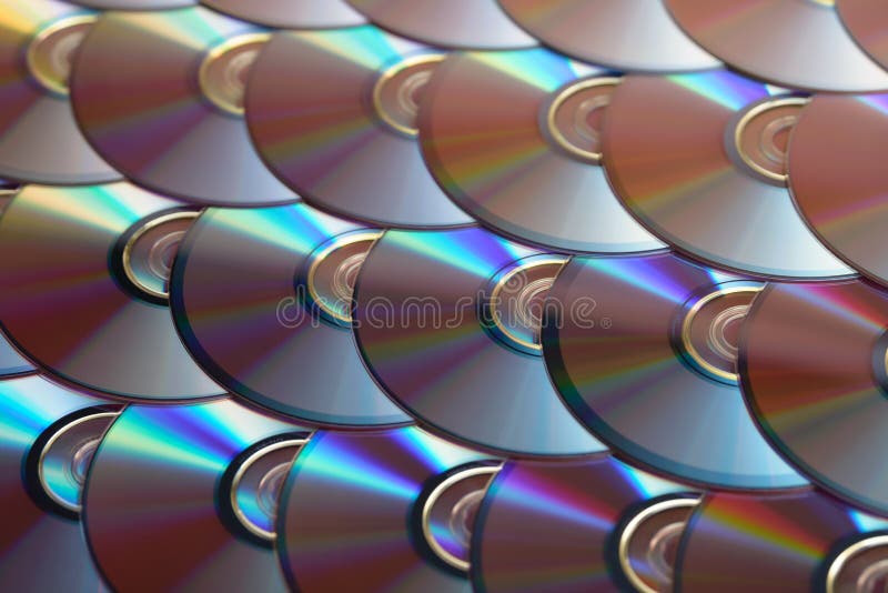 Compact discs background. Several cd dvd blu-ray discs. Optical recordable or rewritable digital data storage. royalty free stock photo