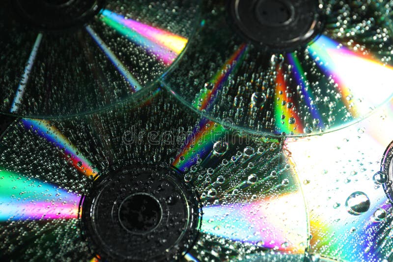 Compact discs with drops as background, closeup stock photography