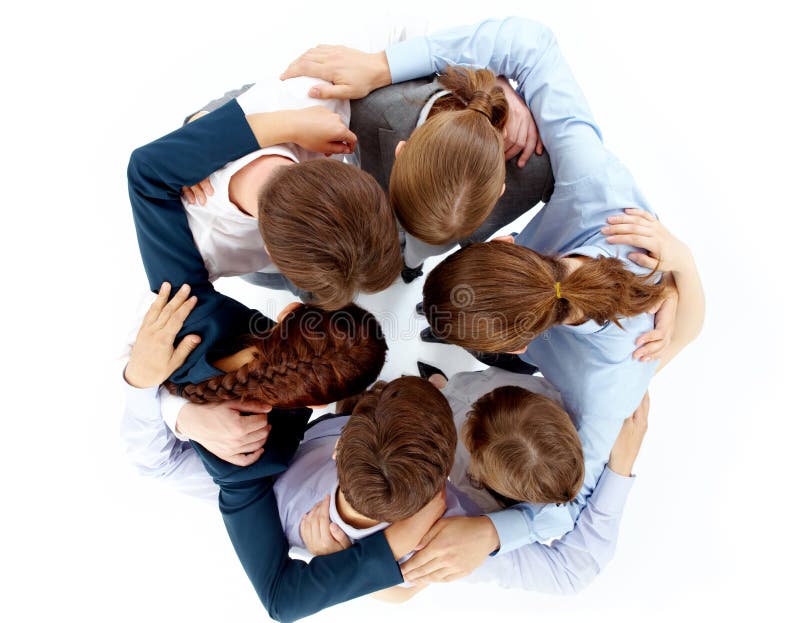 Above view of several business partners nodding heads and embracing each other standing in circle. Above view of several business partners nodding heads and embracing each other standing in circle