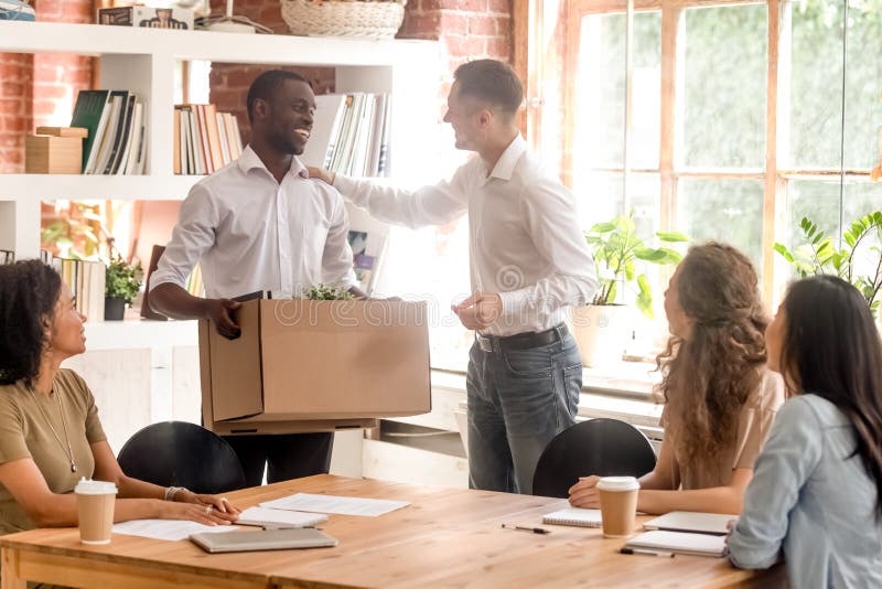 Company boss and staff gathered in office greeting newcomer employee stock photography Company boss and staff gathered in office greeting newcomer employee stock photography