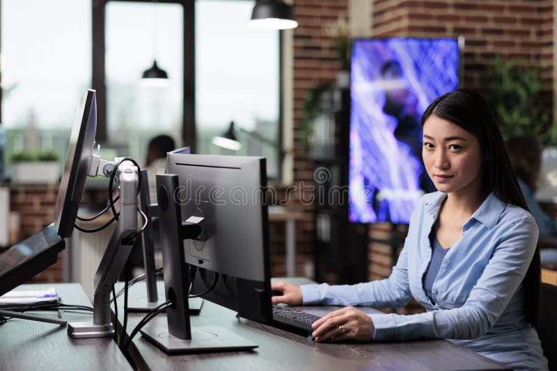 Company office worker in production department working on computer while designing modern graphics. stock photo