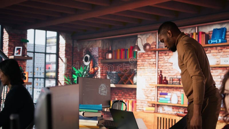 Man entering startup agency office holding laptop stock video footage