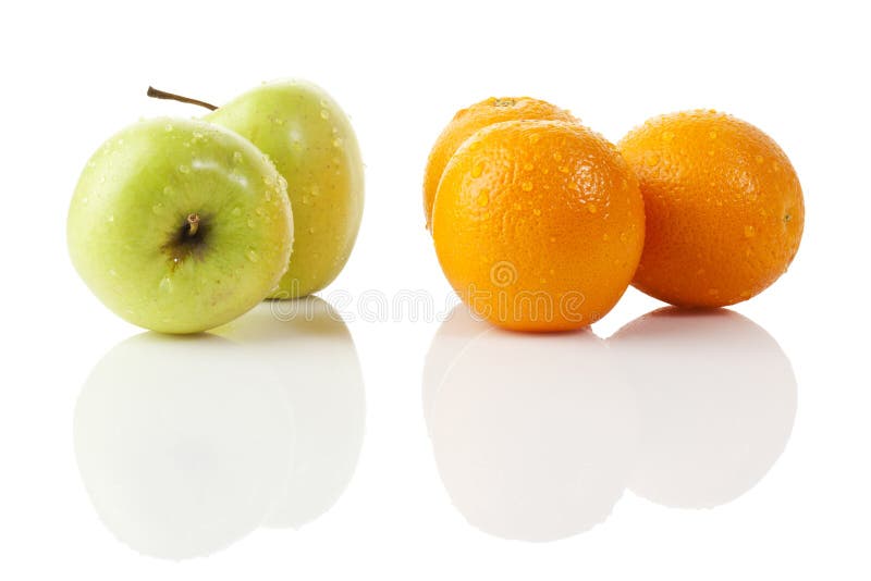 Two green apples and three oranges with waterdrops on white background. Two green apples and three oranges with waterdrops on white background