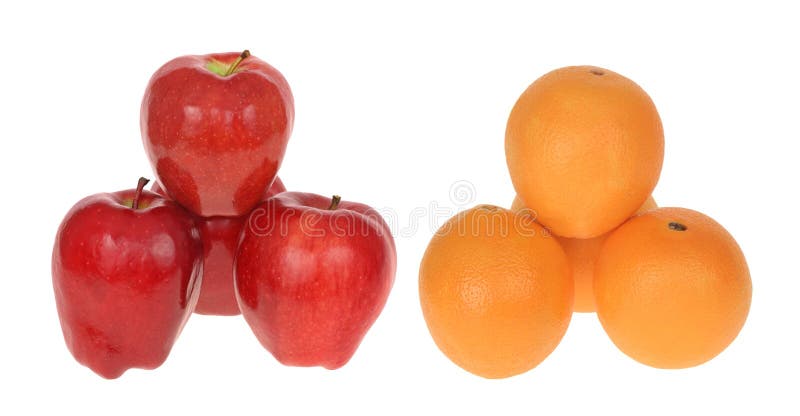 Stack of apples next to stack of oranges to compare apples to oranges isolated on white. Stack of apples next to stack of oranges to compare apples to oranges isolated on white