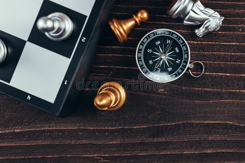 compass and chess piece on chess board game for ideas, challenge,  leadership, strategy, business, success or abstract - Stock Image -  Everypixel