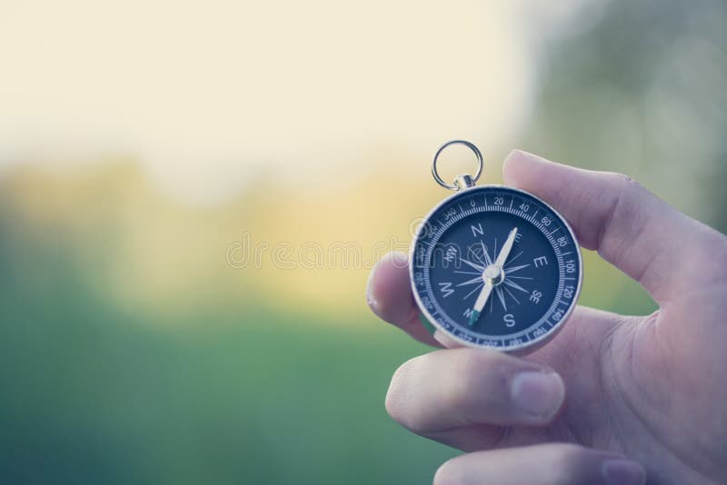 Compass holding in the hand, outdoor adventure