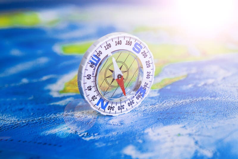 Compass on map. The magnetic compass is located on a geographic map. Satellites adventure. Travel concept. stock photography Compass on map. The magnetic compass is located on a geographic map. Satellites adventure. Travel concept. stock photography