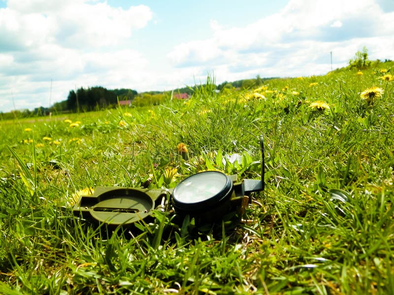 Compass on the Meadow Travel and Vacations Concept Stock Photo