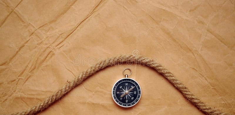 Compass and rope on old paper