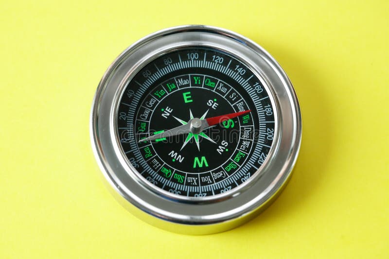 Compass on Yellow stock image. Image of arrow, object 270660689