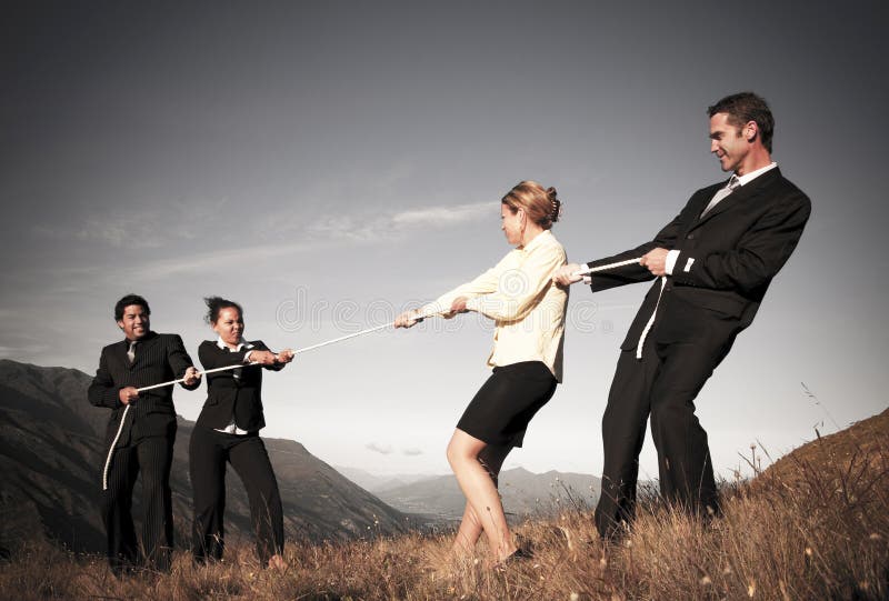 Competitive Business People Struggling To Win Tug-Of-Wars
