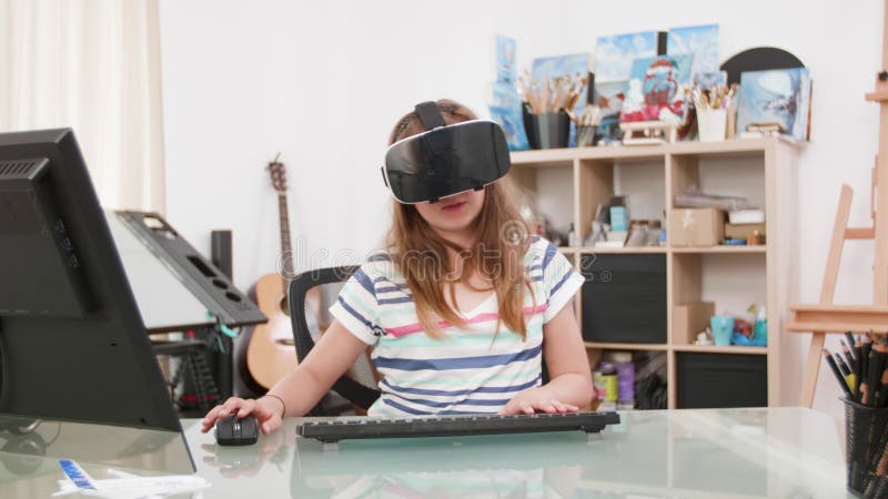 Man playing multiplayer online action game while gaming girl is fighting in  virtual reality game at home. Gamer streaming first person shooter on pc  while girlfriend uses vr goggles for simulation Stock