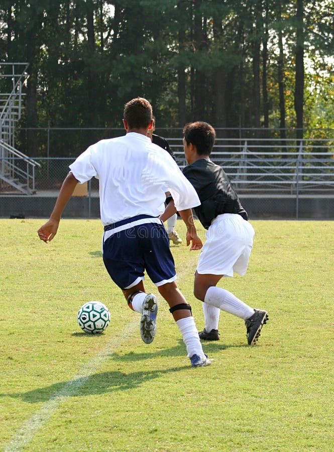 Two soccer players running for the ball. Two soccer players running for the ball.