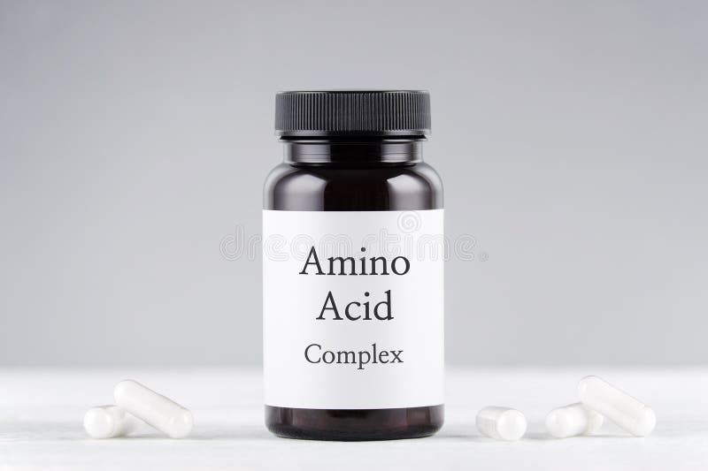 Nutritional supplement amino acids bottle and capsules on gray background. Nutritional supplement amino acids bottle and capsules on gray background