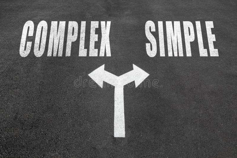 Complex vs simple choice concept, two direction arrows on asphalt. Complex vs simple choice concept, two direction arrows on asphalt.