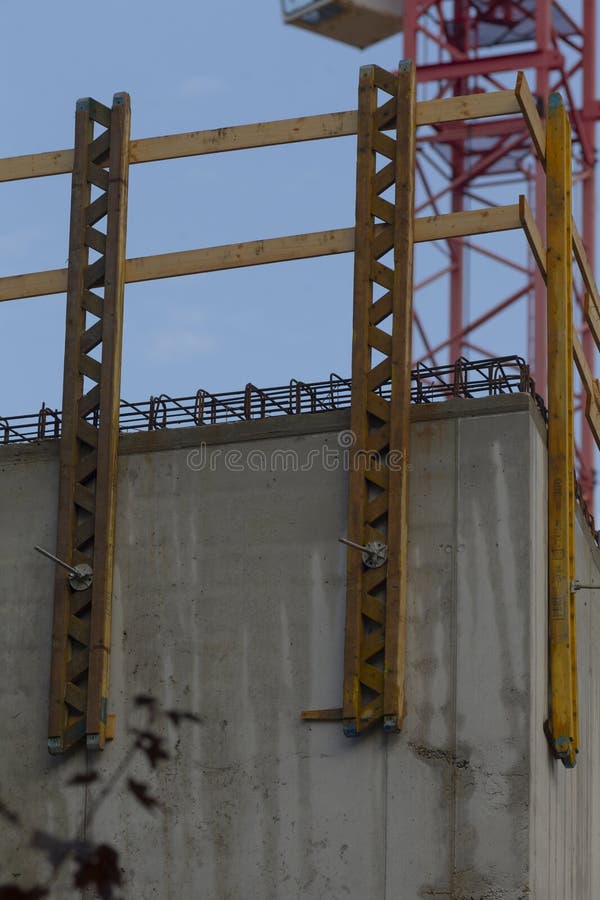 Concrete edge with tower elements and formwork lines, yellow supports and scaffold interplay under pale sky,. Load structural stock images, royalty-free photos and pictures