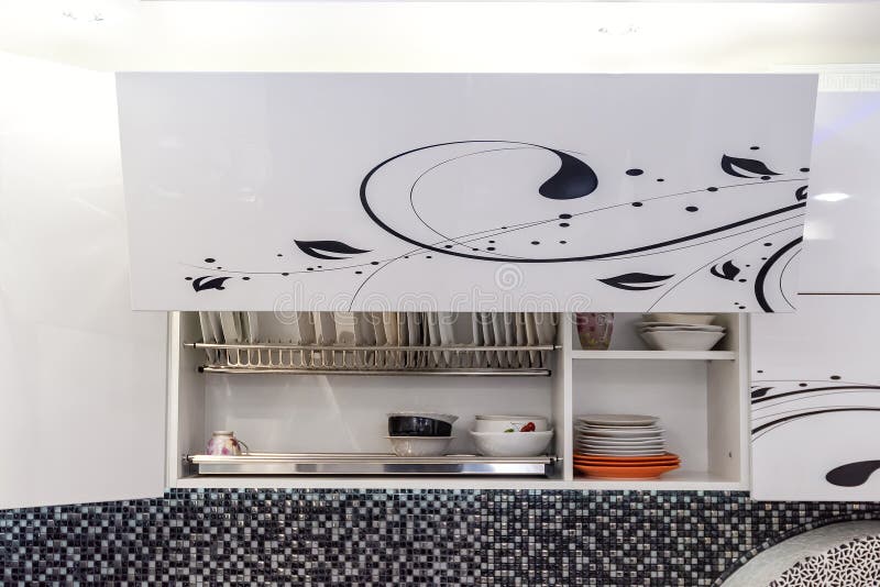 Completely Opened White Kitchen with Plates and Glasses on