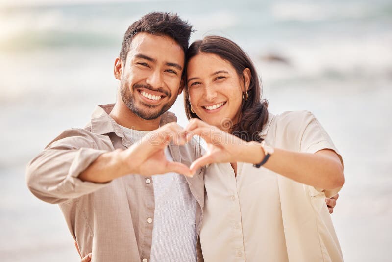 Youve Taught Me The True Meaning Of Love. A Couple Forming A Heart Shape  With Their Hands While Sitting On The Beach. Stock Photo, Picture and  Royalty Free Image. Image 198911221.