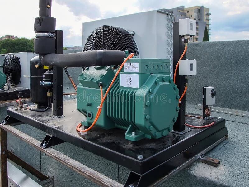 Complex industrial HVAC unit is mounted securely on a flat roof, showcasing its intricate system and design. stock photography