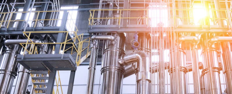 A complex network of pipes and vessels in a modern chemical processing facility stock photo