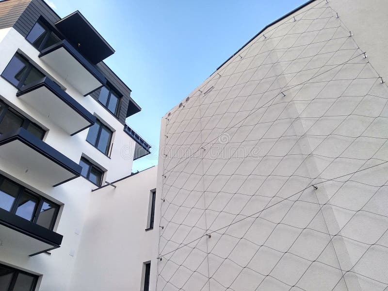 Complexo residencial do multi-andar moderno na cidade muro de cimento branco da casa com Windows e de loggias em um dia ensolarad fotografia de stock Complexo residencial do multi-andar moderno na cidade muro de cimento branco da casa com Windows e de loggias em um dia ensolarad fotografia de stock