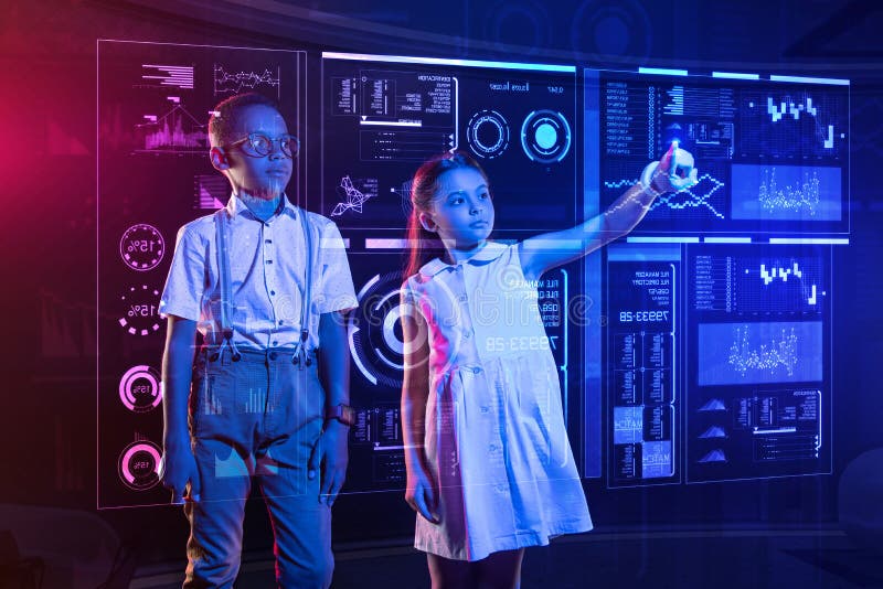 Emotional boy looking shocked while a girl showing him a futuristic device stock image Emotional boy looking shocked while a girl showing him a futuristic device stock image