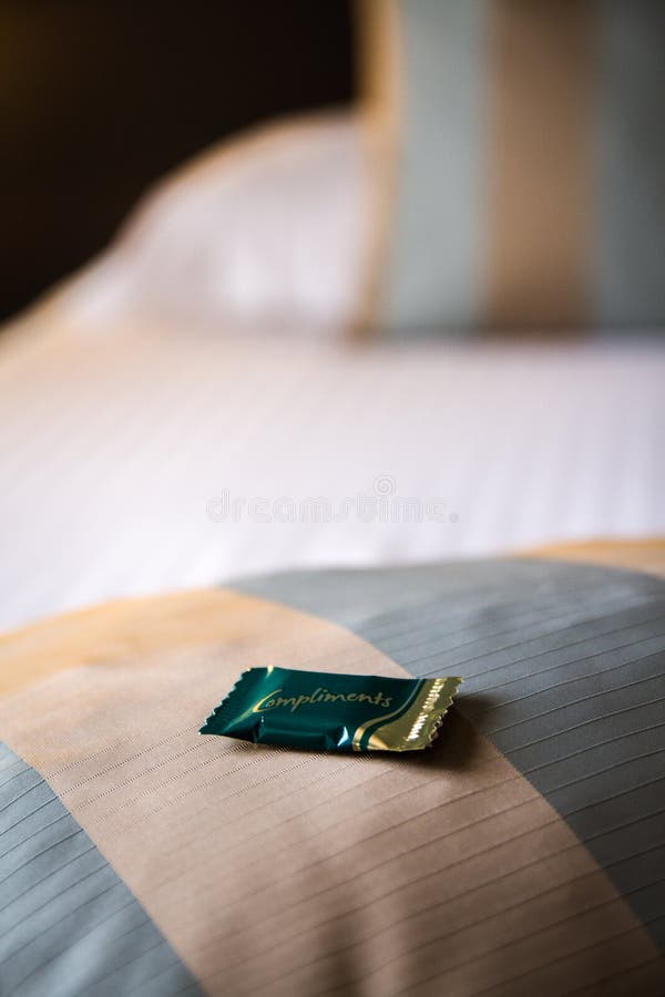 Complimentary Chocolate on a Hotel Bed Stock Photo Image of