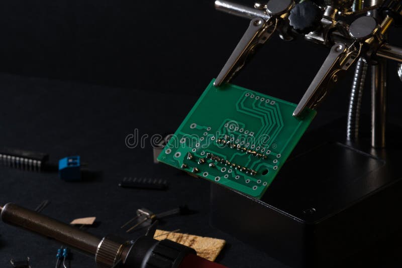 The components of the main board in the process of assembling the finished device for further use. stock images
