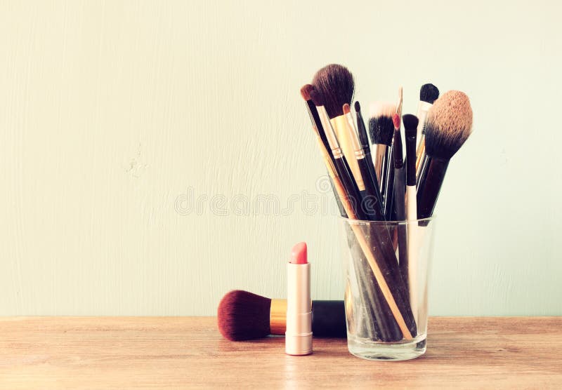 Make up brushes over wooden table pic. Make up brushes over wooden table pic