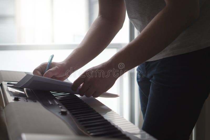 Composer and songwriter writing notes or lyrics on paper stock image Composer and songwriter writing notes or lyrics on paper stock image