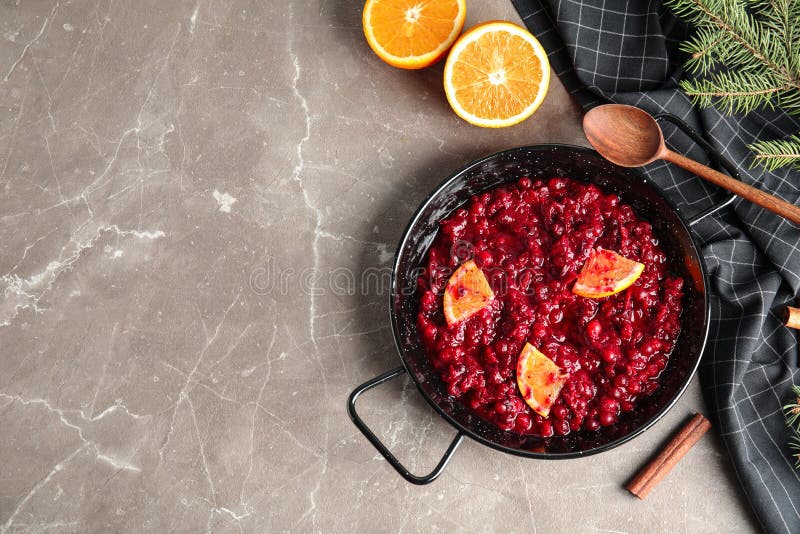 Flat lay composition with cranberry sauce in pan on table. Space for text. Flat lay composition with cranberry sauce in pan on table. Space for text