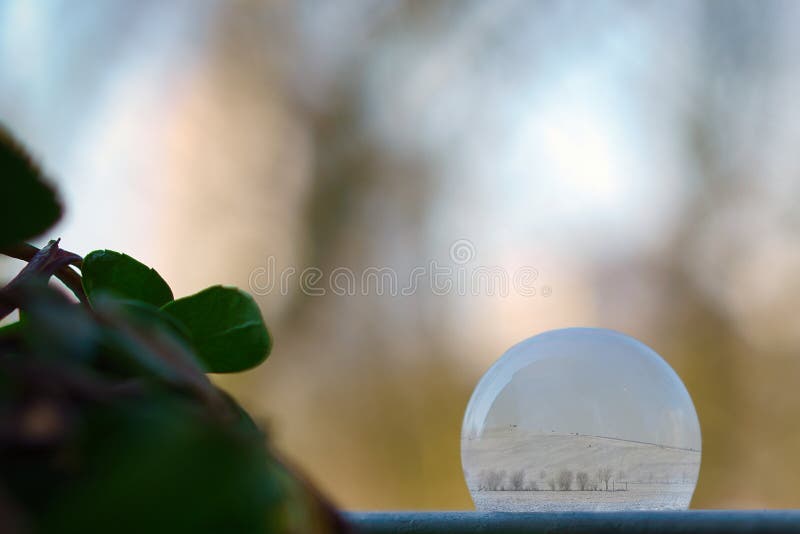 Composing. Frozen soap bubble with winter landscape inside. Winter scene. Ice crystals. Soap snowflake stock images, royalty-free photos and pictures