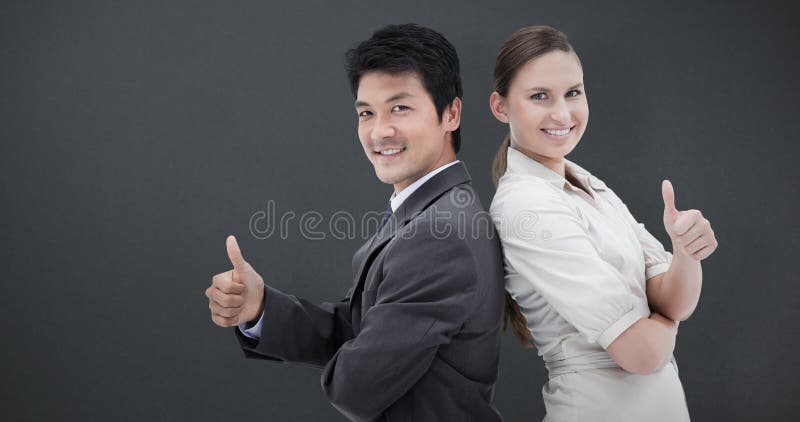 Composite image of business people standing back-to-back with the thumb up stock photography