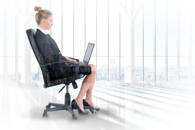 Businesswoman sitting on swivel chair with laptop against room with large window looking on city. Businesswoman sitting on swivel chair with laptop against room with large window looking on city