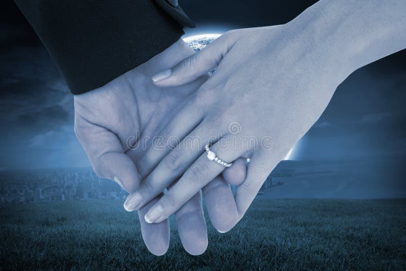 Composite image of close-up of bride and groom with hands together