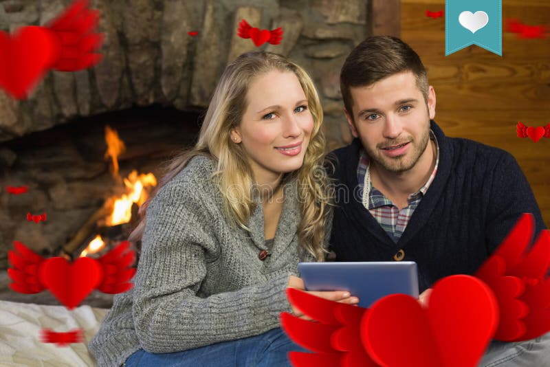 Composite image of couple using tablet pc in front of lit fireplace vector illustration
