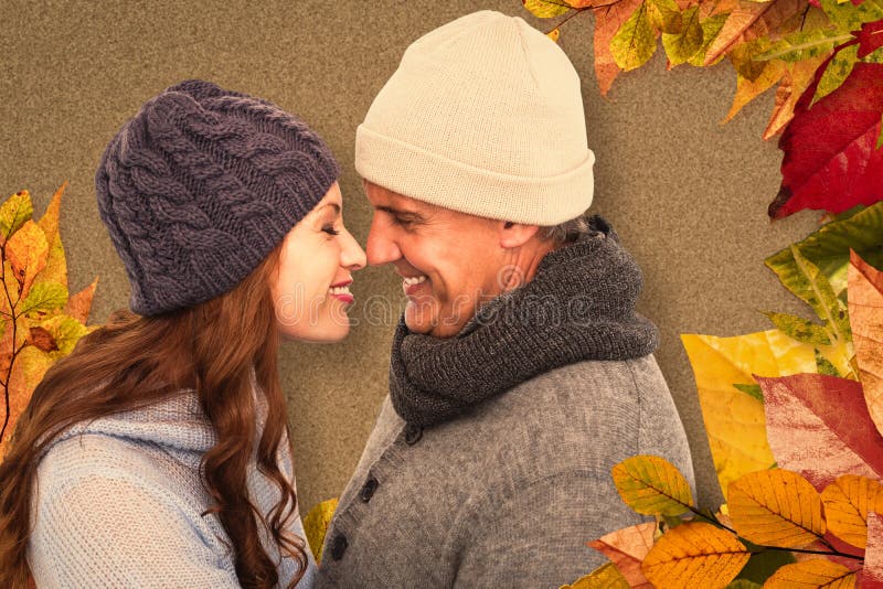 Couple in warm clothing facing each other against autumn leaves pattern. Couple in warm clothing facing each other against autumn leaves pattern