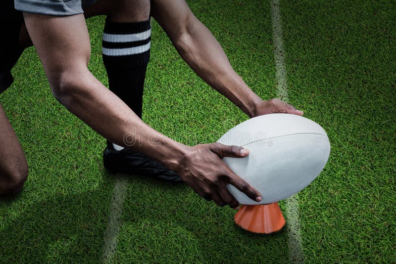 Composite Image of Cropped Image of Sportsman Keeping Rugby Ball on