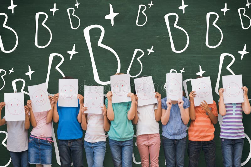 Composite image of cute pupils with funny faces in classroom royalty free stock image