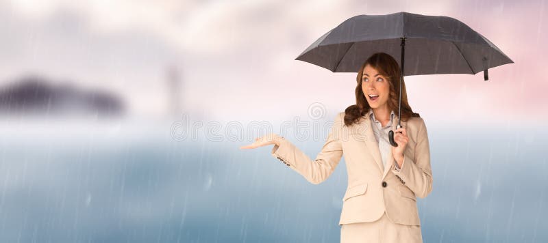 Composite image of elegant businesswoman holding black umbrella stock photography
